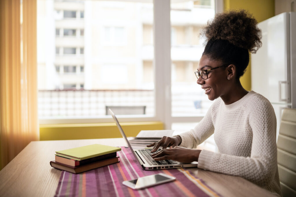 Woman sitting at home using laptop